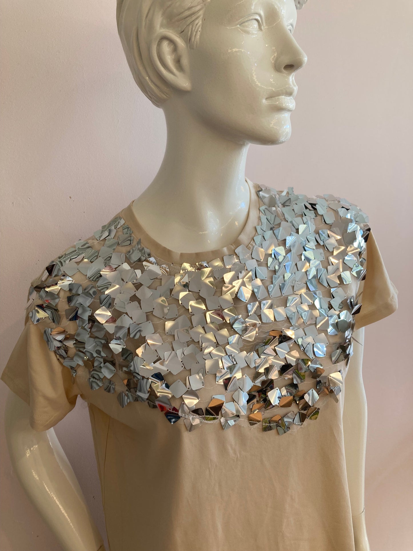 Beige top with large silver sequin on the front