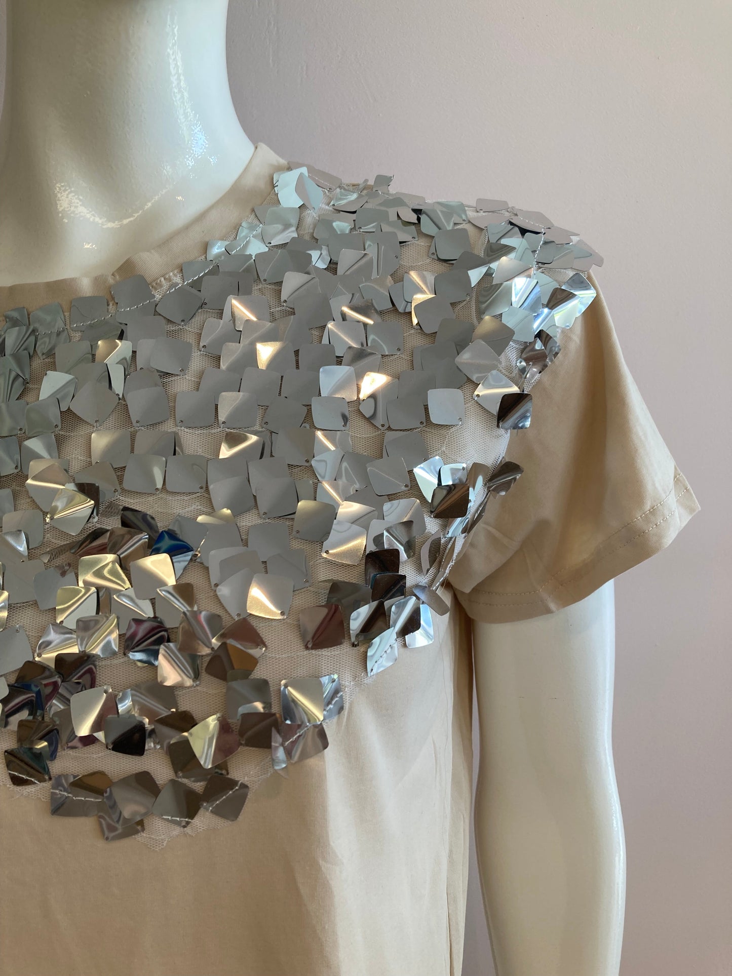 Beige top with large silver sequin on the front