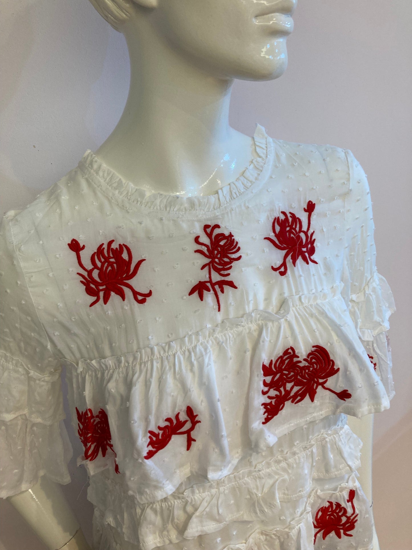 White top with ruffle and red embroidery